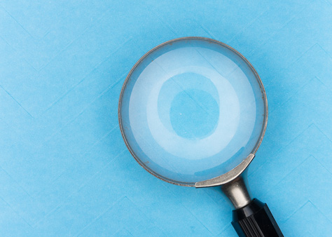A magnifying glass on a blue background