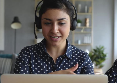 Woman wearing a headset at a laptop